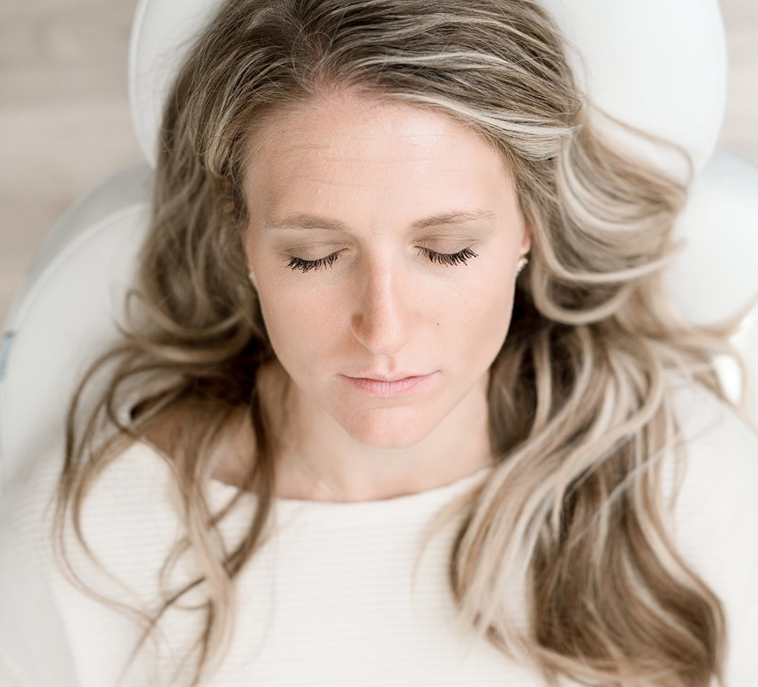 Woman with closed eyes and long hair.