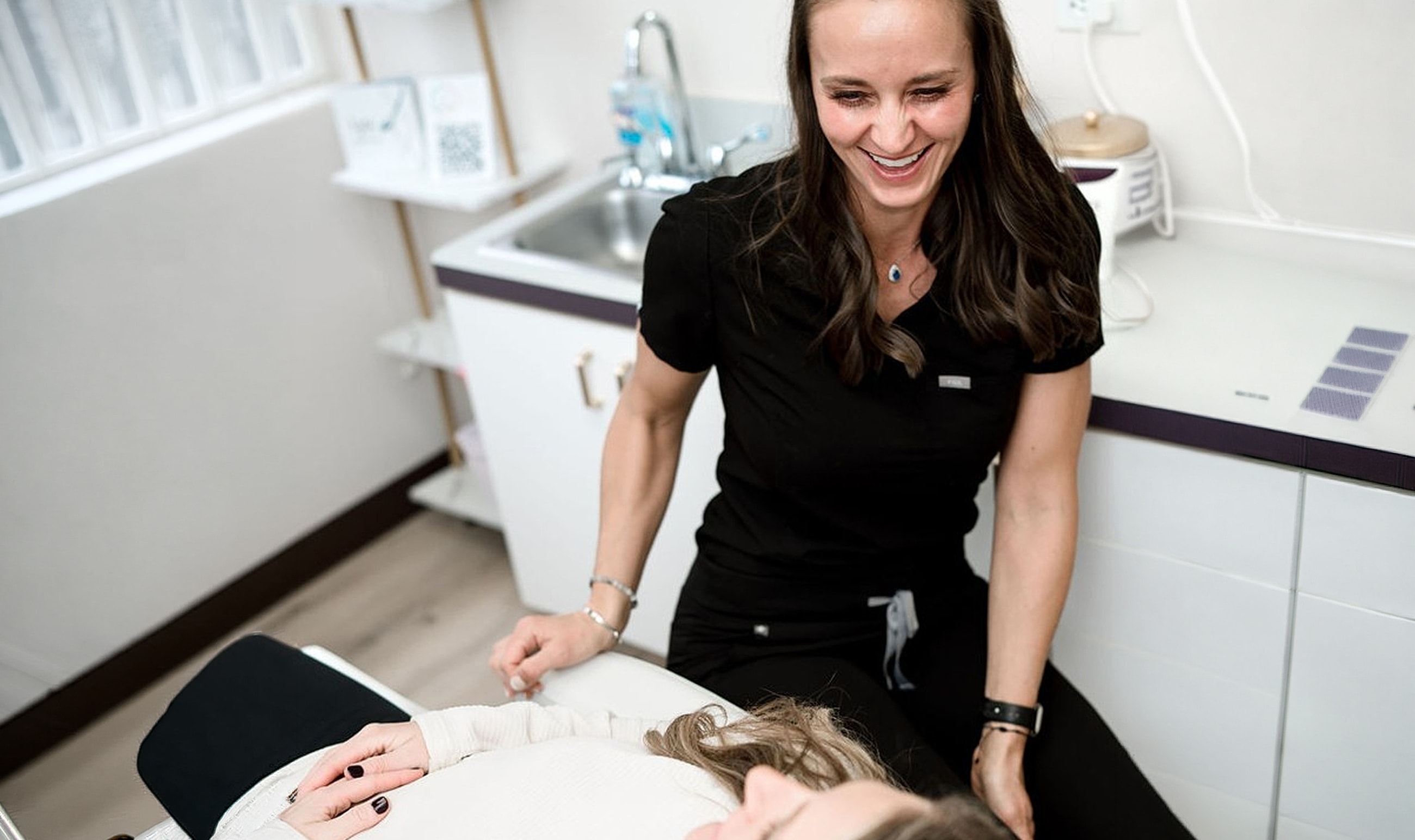 Dental professional interacting with patient in clinic.